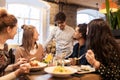 Happy friends eating and drinking at restaurant Royalty Free Stock Photo