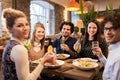 Happy friends eating and drinking at restaurant Royalty Free Stock Photo