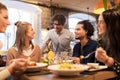 Happy friends eating and drinking at restaurant Royalty Free Stock Photo