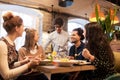 Happy friends eating and drinking at restaurant Royalty Free Stock Photo