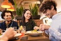 Happy friends eating and drinking at restaurant Royalty Free Stock Photo