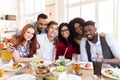 Happy friends eating at restaurant