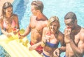 Happy friends eating watermelon in swimming pool hotel resort -  Diverse culture couples having fun in summer vacation - Travel, Royalty Free Stock Photo