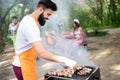 Happy friends enjoying barbecue and grill party outdoor Royalty Free Stock Photo