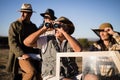 Happy friends enjoying in vehicle during safari vacation Royalty Free Stock Photo