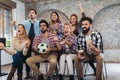 Happy friends or football fans watching soccer on tv and celebrating victory Royalty Free Stock Photo