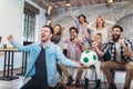 Happy friends or football fans watching soccer on tv Royalty Free Stock Photo