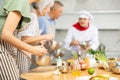 Happy friends and friendly chef cook cooking in kitchen. Learn to beat eggs Royalty Free Stock Photo