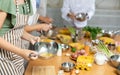 Happy friends and friendly chef cook cooking in kitchen. Learn to beat eggs Royalty Free Stock Photo