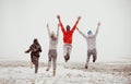 Happy friends friendship run jump first snow Royalty Free Stock Photo