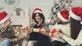 Happy friends giving Christmas presents to girlfriend Royalty Free Stock Photo