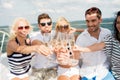 Happy friends with glasses of champagne on yacht Royalty Free Stock Photo