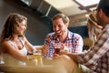 Happy friends having fun at bar - Young trendy people drinking beer and laughing together Royalty Free Stock Photo