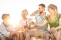 Happy friends group having fun at beach party drinking cocktails Royalty Free Stock Photo