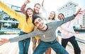 Multiracial young people group with hands up smiling at camera together Royalty Free Stock Photo