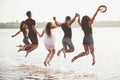 Happy friends have fun on the beach - Young people playing in open air water on summer holidays Royalty Free Stock Photo