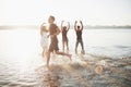 Happy friends have fun on the beach - Young people playing in open air water on summer holidays Royalty Free Stock Photo