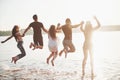 Happy friends have fun on the beach - Young people playing in open air water on summer holidays Royalty Free Stock Photo