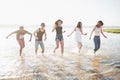 Happy friends have fun on the beach - Young people playing in open air water on summer holidays Royalty Free Stock Photo