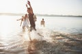 Happy friends have fun on the beach - Young people playing in open air water on summer holidays Royalty Free Stock Photo