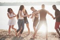 Happy friends have fun on the beach - Young people playing in open air water on summer holidays Royalty Free Stock Photo