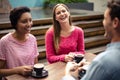 Happy friends having coffee together Royalty Free Stock Photo