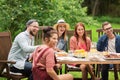 Happy friends having dinner at summer garden party Royalty Free Stock Photo