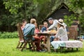 Happy friends having dinner at summer garden party Royalty Free Stock Photo