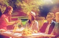 Happy friends having dinner at summer garden party Royalty Free Stock Photo