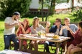 Happy friends having dinner at summer garden party Royalty Free Stock Photo