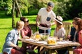 Happy friends having dinner at summer garden party Royalty Free Stock Photo