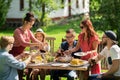 Happy friends having dinner at summer garden party Royalty Free Stock Photo