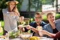 Happy friends having dinner at summer garden party Royalty Free Stock Photo