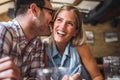 Happy friends having fun at bar - Young trendy couple drinking beer and laughing together Royalty Free Stock Photo