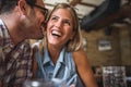 Happy friends having fun at bar - Young trendy couple drinking beer and laughing together Royalty Free Stock Photo