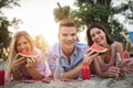 Happy friends having fun on the beach and eating watermelon. Royalty Free Stock Photo