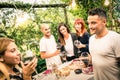 Happy friends having fun drinking red wine at backyard garden Royalty Free Stock Photo