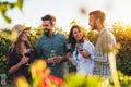 Group of young people tasting wine in winery near vineyard Royalty Free Stock Photo