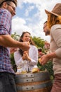 Group of young people tasting wine in winery near vineyard Royalty Free Stock Photo