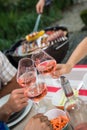 Happy friends having fun outdoors, hands toasting rose wine glass Royalty Free Stock Photo