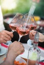 Happy friends having fun outdoors, hands toasting rose wine glass Royalty Free Stock Photo