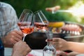 Happy friends having fun outdoors, hands toasting rose wine glass Royalty Free Stock Photo