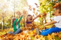Happy friends having fun with thrown leaves Royalty Free Stock Photo