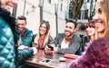 Happy friends having fun together at outdoor location - Young people influencers talking and sharing content with mobile phone Royalty Free Stock Photo