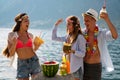 Happy friends having fun with tropical cocktails on beach party. Travel and summer vacation concept. Royalty Free Stock Photo