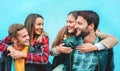 Happy friends having fun with turquoise wall background - Students laughing together outside of university university - Youth and Royalty Free Stock Photo