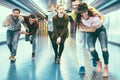 Happy friends having fun in underground metropolitan station - Young people hanging out ready for party night - Friendship, Royalty Free Stock Photo