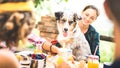 Happy friends having healthy pic nic breakfast at countryside farm house - Young people millennials with cute dog having fun Royalty Free Stock Photo