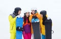 Happy friends in helmets with snowboards talking Royalty Free Stock Photo