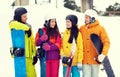Happy friends in helmets with snowboards talking Royalty Free Stock Photo